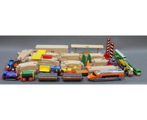 A wooden Brio train set, a small group of Ertl die cast model Thomas the Tank Engine trains, plastic level crossings and sign