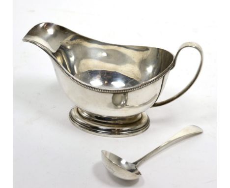 A silver pedestal sauce boat, Birmingham 1933; and a matched sauce ladle (2) 6.4ozt