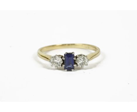 A gold step cut sapphire and diamond three stone ring, marked 18ct and Plat2.50g