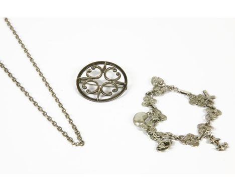 A collection of silver jewellery to include a silver cross with engraved decoration, a silver three row watch chain with tass