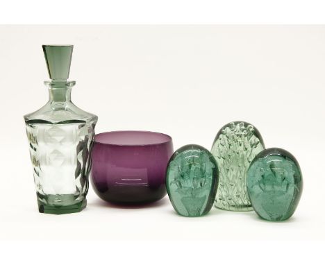 Three Victorian green glass dump weights, tallest 12.5cm, a green glass decanter and stopper, and an amethyst glass bowl (5)