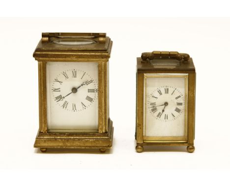Two miniature carriage brass clocks, having white enamel dials and Roman numerals (2)