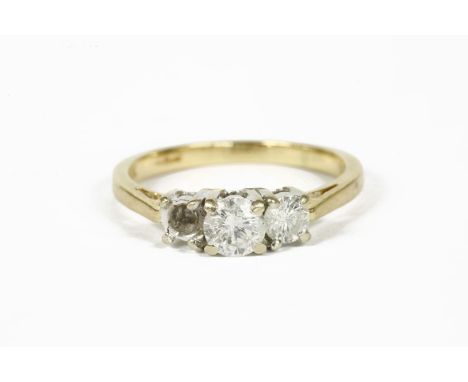 An 18ct gold three stone diamond ring, with IGI mini report, dated 9/12/2002 no. f3C48702 stated diamond weight when complete