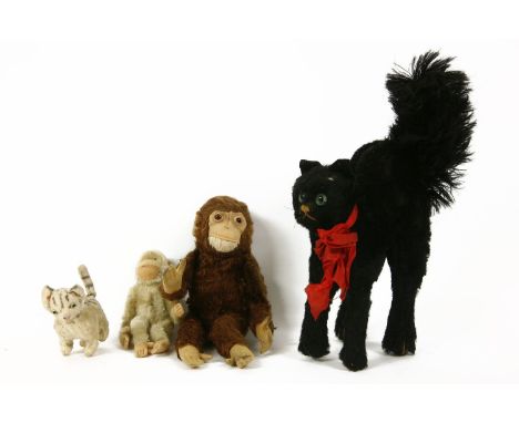 Steiff toys, a halloween cat, two monkeys, and a tabby cat
