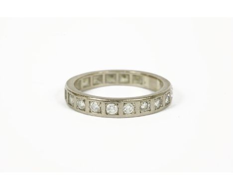 A white gold diamond half eternity ring, (tested as approximately 18ct white gold) one stone deficient4.95g