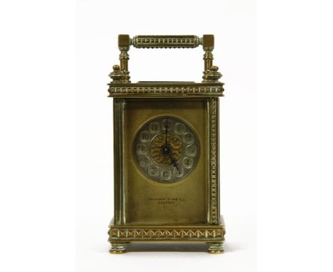 A brass carriage clock, with a silvered dial, Arabic numerals, with concave discs