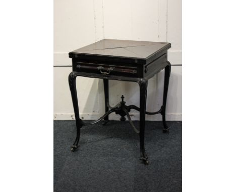 An Edwardian mahogany envelope card table with green baize liner and recessed counter dishes, above single drawer, on carved 