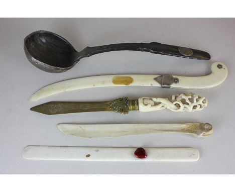 An ivory handled gilt metal paper knife, three other paper knives and a horn ladle (a/f) (NC)