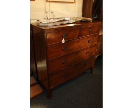 A George III mahogany chest of two short over three long drawers, with drop ring handles, on bracket feet, 107cm