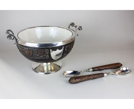 A silver plate mounted teak salad bowl carved with floral designs, with twin scroll handles and vacant cartouche, with matchi