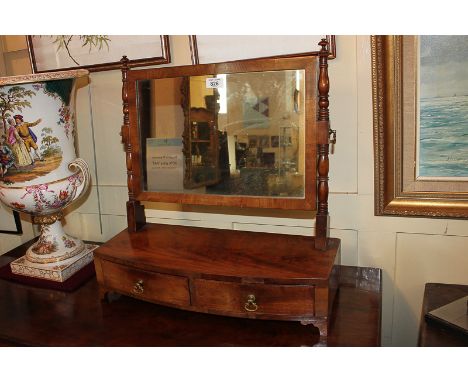 A George III mahogany bow front dressing table mirror with turned supports, on box base with two drawers, on bracket feet, 52