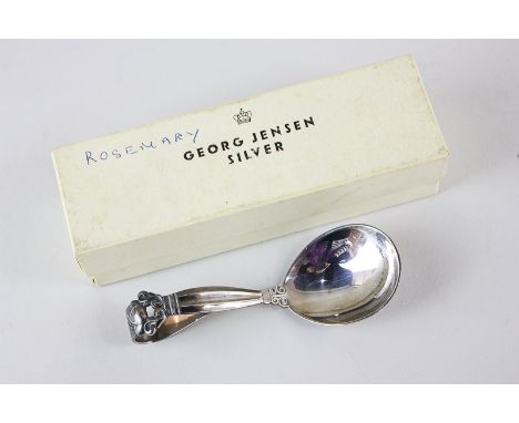 A George Jensen sterling silver caddy spoon, the handle with scroll design bearing London 1948 import marks, in original box