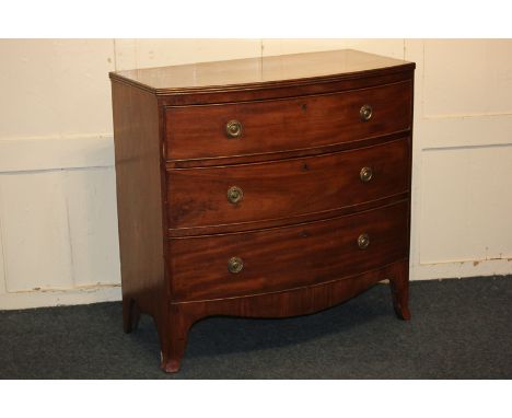 A George III mahogany bow front chest of three graduated drawers with brass ring handles, on splayed bracket feet, 90cm