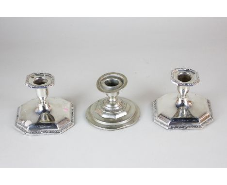 A pair of white metal octagonal dwarf candlesticks marked 830, together with another unmarked white metal circular dwarf cand