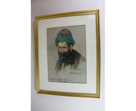 Early 20th century portrait of a Middle Eastern man in green and red hat, pastel, indistinctly signed, inscribed and dated 19