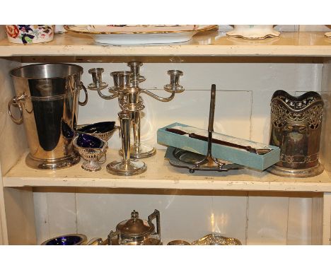 A pair of silver plated three-sconce candelabra, two wine coolers, a pair of salts, a cake basket and a candle snuffer