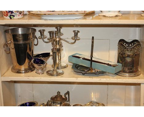 A pair of silver plated three-sconce candelabra, two wine coolers, a pair of salts, a cake basket and a candle snuffer