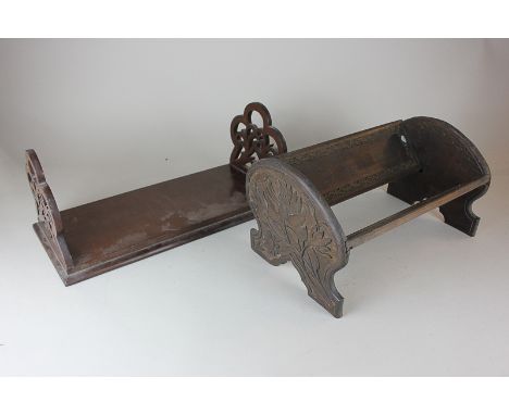 A mahogany book stand with fret cut ends, 40cm, and a book trough carved with flowers, 33cm, (NC)