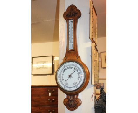 An oak cased wall barometer and thermometer with white enamel dial, 82cm