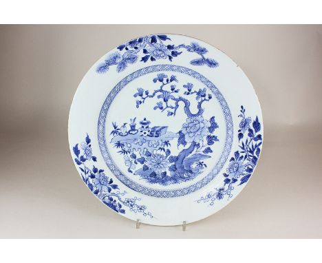 A Chinese blue and white porcelain charger decorated with a blossoming tree and a calligrapher's table, 34cm, (a/f)