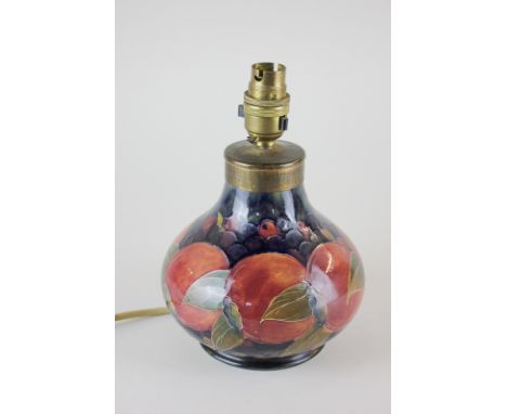 A Moorcroft pottery table lamp in pomegranate pattern, W Moorcroft signature to base, 21cm high