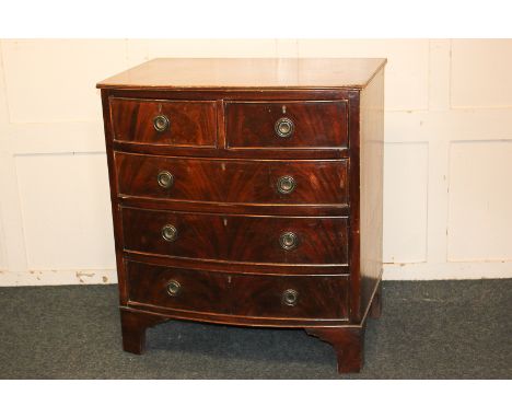 A mahogany bow front chest of two short over three long drawers with ring handles, on bracket feet, 77cm