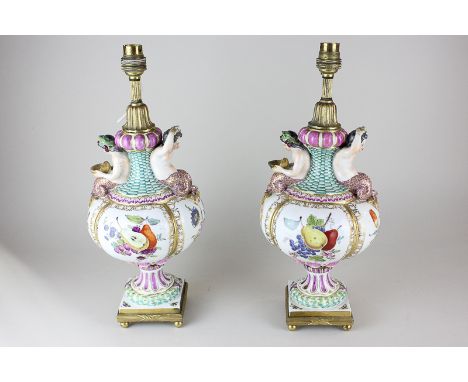 A pair of Dresden porcelain Meissen style urns, now as table lamps, decorated with four hand painted panels of fruit and flow