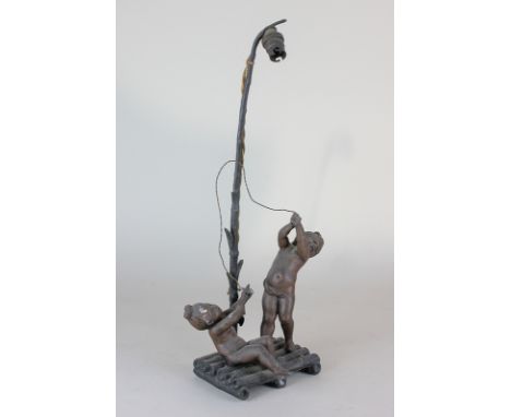 A bronzed spelter figural table lamp, with two cherubs on a raft (af) 38cm high (NC)