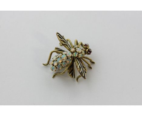 An opal set gold bee brooch with ruby eyes