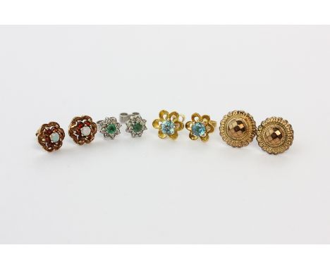 A pair of blue zircon ear studs; a pair of emerald and diamond ear studs, a pair of opal and garnet ear studs; a pair of gold