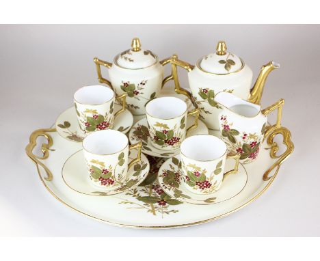 A Limoges porcelain tea/coffee service comprising teapot, sugar bowl and cover, milk jug, four cups and saucers and a circula