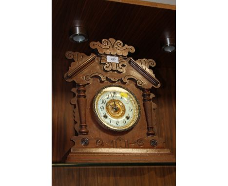 AN AMERICAN STYLE CARVED MANTEL CLOCK