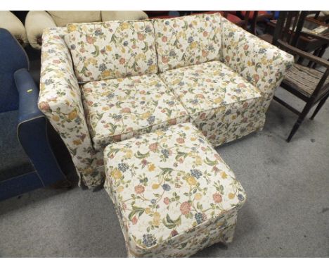 A FLORAL TWO SEATER SOFA & TWO FOOT RESTS