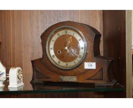 A CARVED ENFIELD ROYAL OAK MANTLE CLOCK