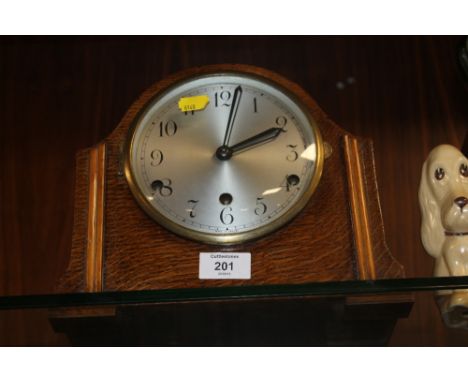 AN OAK MANTEL CLOCK