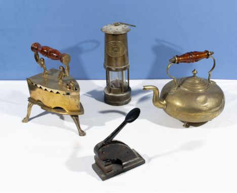 A brass iron and stand, brass kettle, Davy lamp and an embosser stamp (13 High St Hawick)