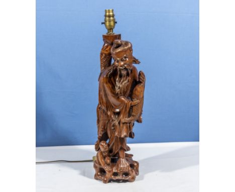 A carved wood sage converted to a lamp 42cm tall