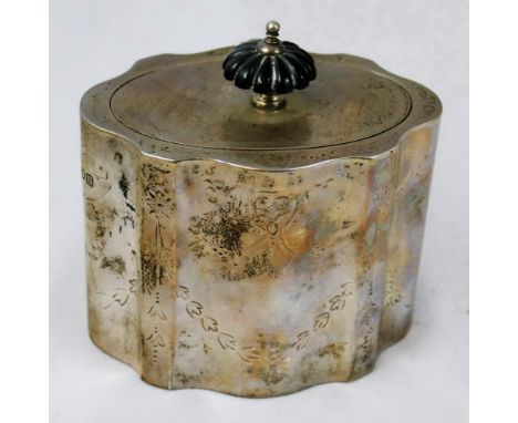 An Edwardian silver tea caddy, London 1907, of oval shaped form with bright cut engraved decoration, ebony finial, vacant car