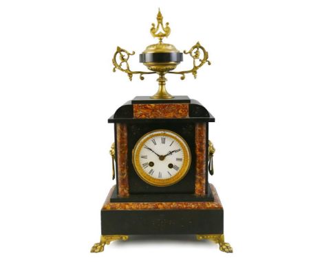 A French black slate and variegated marble garniture,  the mantle clock with a white enamel dial with black Roman numerals, t