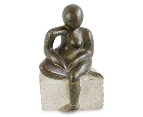 A carved serpentine stone figure of a seated female, modelled sitting cross-legged on boulder signed Fox, carved from the sol