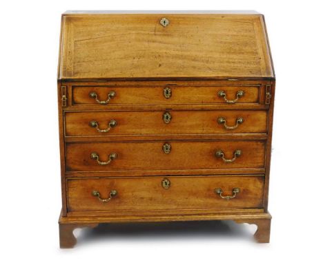 A George III mahogany bureau, the fall front opening to reveal a fitted interior with inset writing surface, pigeon holes, dr