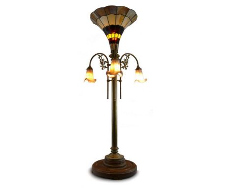 An early 20th century brass newel post lamp, the central uplighter with metal and multi-coloured simulated shell shade in the