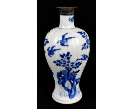 An 18th century Chinese blue and white porcelain vase with ribbed body painted with stylised birds and floral sprays, with la