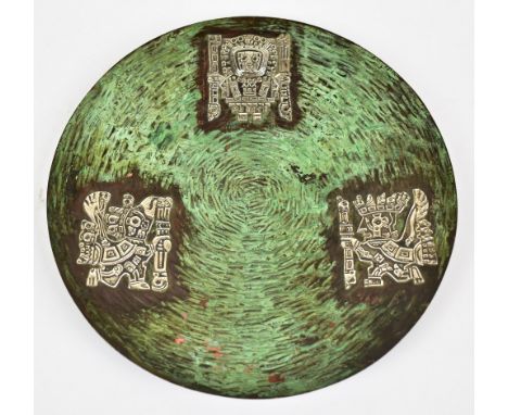 VICKI; a Peruvian beaten copper plate with patinated finish and white metal inlay depicting Inca deities, stamped manufacture