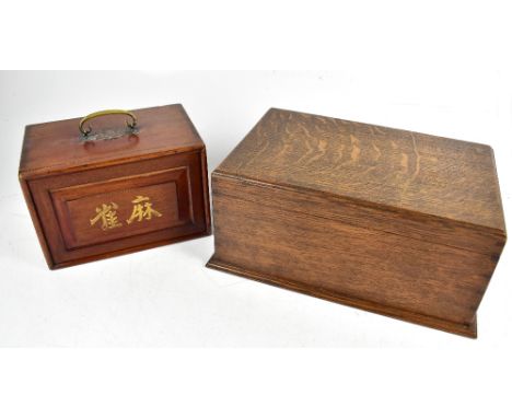 An early 20th century Chinese Mah-jong set with bone and bamboo tiles, Chad Valley score card and calculator and two further 