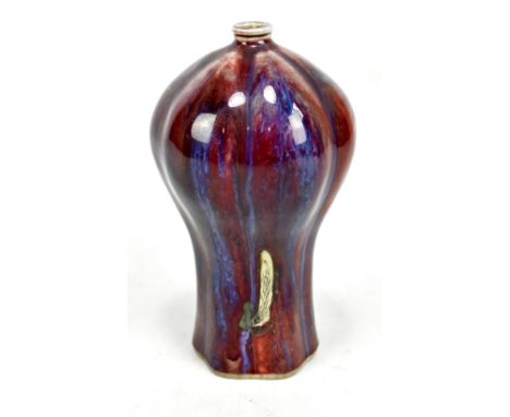 An 18th century Chinese flambé glazed vase of lobed form with rich red ground and blue/purple hue throughout, with an area of