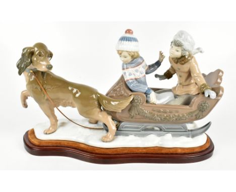 LLADRO; a large figure group, 'Sleigh Ride' No.5037, raised on wooden plinth base, length 45cm.Additional InformationA craze 