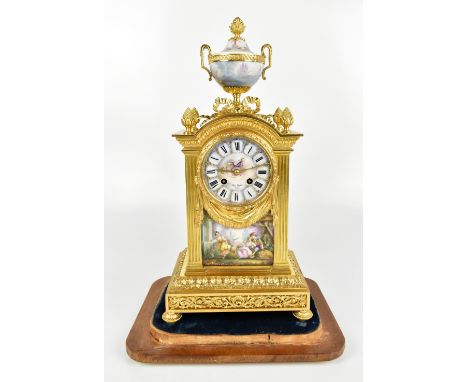 HENRY MARC OF PARIS; a 19th century gilt metal mantel clock with urn finial with painted porcelain panels depicting classical