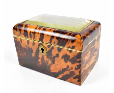 A 19th century tortoiseshell tea caddy of rectangular form with glazed top, the hinged cover enclosing a silvered liner, leng