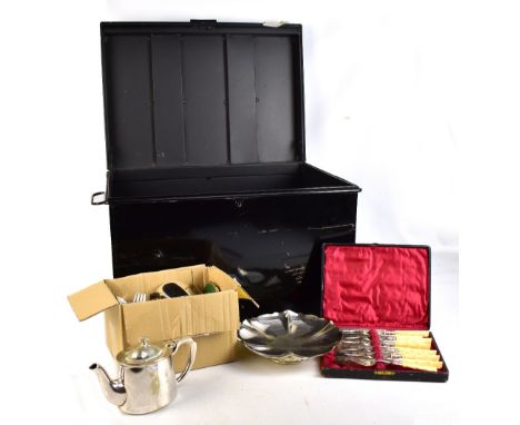 A tin trunk containing a quantity of silver plate, predominately flatware, also a hot water pot, a swing handled basket, etc.